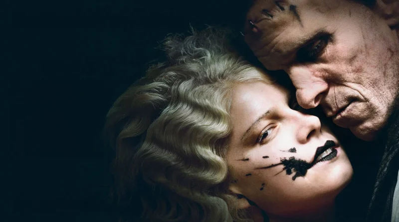 Fotografia em close-up com fundo escuro destacando os atores Jessie Buckley e Christian Bale caracterizados para o filme A Noiva. Jessie, em primeiro plano, possui cabelos loiros ondulados em estilo vintage e uma maquiagem preta borrada de forma expressiva ao redor dos lábios e da bochecha. Christian Bale está com o rosto colado ao dela, olhando para baixo, exibindo cicatrizes marcantes e pontos cirúrgicos na testa e no rosto, remetendo ao visual clássico do Monstro de Frankenstein. O clima da imagem é sombrio, gótico e intimista.